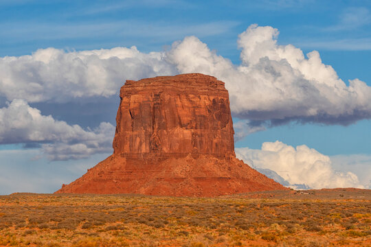 Merrick Butte, a rock formation in Monument Valley, Arizona.  The red rock glows at sunset as the light hits them; Arizona, United States of America
