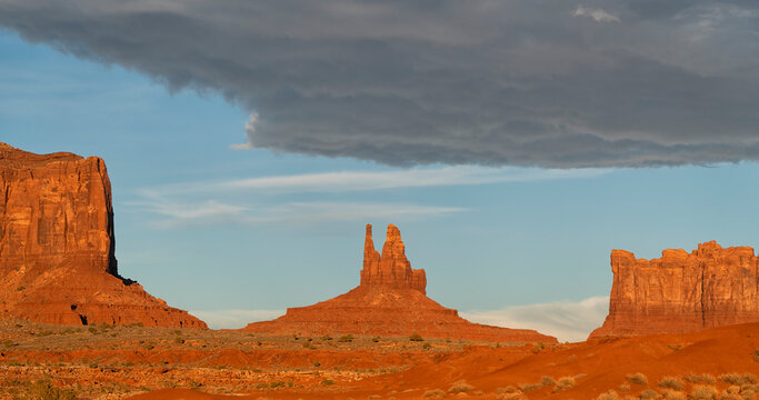 Rock formations of Monument Valley, Arizona.  The red rock glows at sunset as the light hits them; Arizona, United States of America