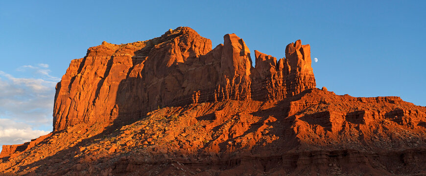 Rock formations in Monument Valley, Arizona.  The red rock glows at sunset as the light hits them; Arizona, United States of America