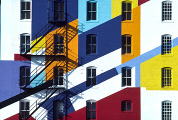 Fire escape on a colorfully painted building; New York City, New York, United States of America