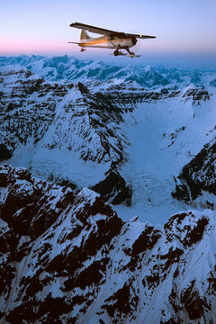 Ski plane flies over Mount Denali in Denali National Park and Preserve; Alaska, United States of America