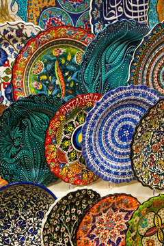 Dishware for sale, colorful plates in rows displayed in a shop in the Spice Bazaar in the Fatih District; Istanbul, Turkey