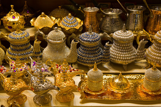 Decorative teapots and traditional Turkish oil lamps for sale in brass, copper and bedazzeled with gems on display in a shop in the Spice Bazaar in the Fatih District; Istanbul, Turkey