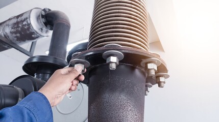 Technician check and inpection the bolt mounting exhaust muffler with flexible metal bellows on the...