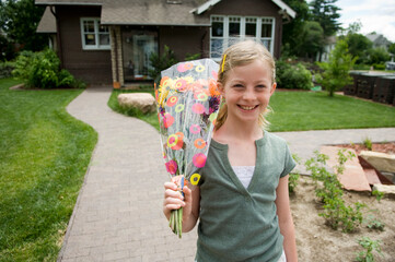 Girl brings home a bouquet of flowers; Lincoln, Nebraska, United States of America