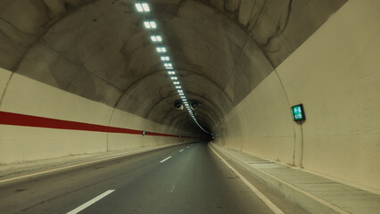  Underground tunnel with car moving on the road in the city. Underground tunnel with light and shadow on the surface of the road