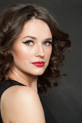 Obraz premium Perfect woman brunette with makeup and shiny wavy brown hair studio portrait. Fashion, make-up, hairstyle, personal care, beauty salon, cosmetics and fashion concept