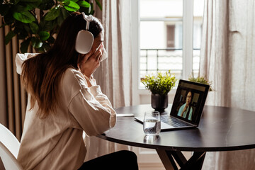 Young depressed woman having online session with psychologist at home. Sad girl crying during...