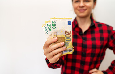 200 euro bills in female hand. 