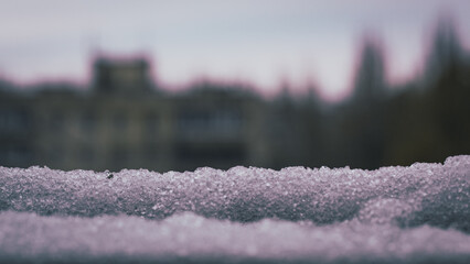 Winter background. Snow in the foreground and blurry background. It's a nasty day. Free space for text.