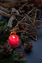deer and pentacle star amulets, burning candle, cones, fir branches on dark abstract background....