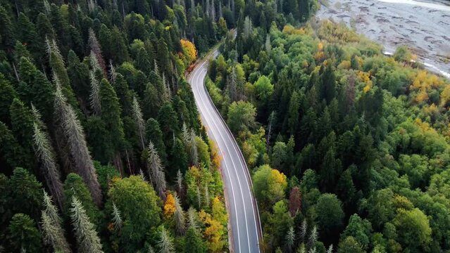 view of the mountain road in the autumn mountains of Dombai, the car is driving along the road