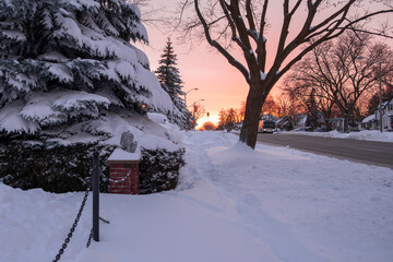 Unplowed uncleaned sidewalk by the road on a residential street completely covered after massive...