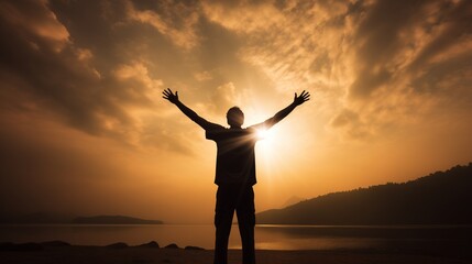 Fototapeta premium Happy man with arms raised up outdoors and beautiful sunset