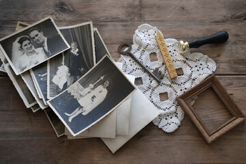 old family photos, pictures from 1940 in sepia color on wooden table, home archive documents, key,...