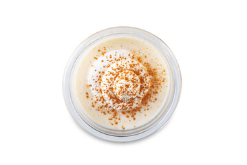 Eggnog with cinnamon decorated with whipped cream in a glass on a white isolated background