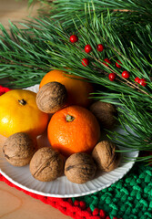 Tangerines and walnuts on a New Year's background.