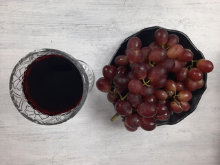red grapes in a basket and wine