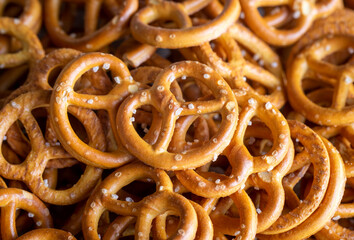 Mini pretzels with salt on wooden background. Selective focus.