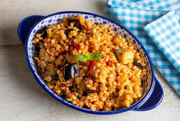 Traditional delicious Turkish food; Bulgur pilaf with eggplant and vegetables. (Turkish name;...