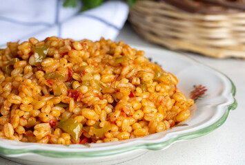 Traditional turkish bulgur pilaf with tomato sause in plate (Turkish name; meyhane pilavi)