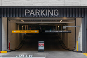 Entrance to parking garage structure with height warning sign