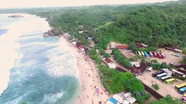 Aerial view of Indrayanti beach, Yogyakarta - Indonesia, beauty of indonesian beach, many people travel to the beach