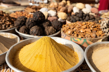 Pyramids of spices and color powder on Egyptian market in Aswan Egypt