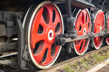 An old steam locomotive of the early 20th century on the railway track.