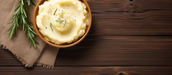 Mashed potato with rosemary and olive oil on wooden table Copy space image Place for adding text or design