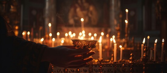 Orthodox funeral service and liturgy in the Church where Christians light candles before the Orthodox cross with the crucifix emphasizing the Orthodox faith Copy space image Place for adding te - obrazy, fototapety, plakaty