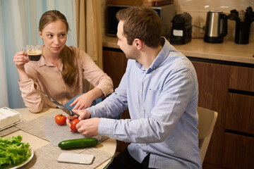 Caucasian romantic couple cooking together in kitchen