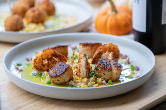 Seared scallops and shrimp on a bed of succotash.