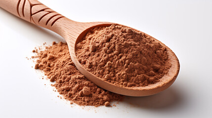 A close-up of a white surface with a wooden spoon and natural henna powder.