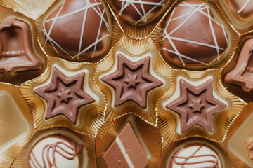 closeup of christmas stars chocolate bonbons