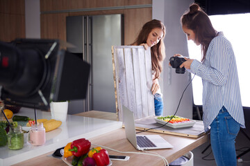 Bloggers photographing food in kitchen