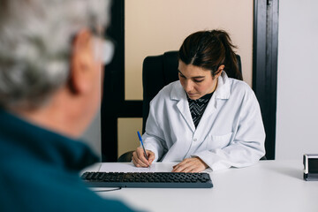 Doctor taking notes during a consultation in medical practice