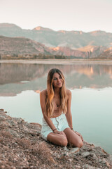 Fototapeta na wymiar Young blond woman at a lake