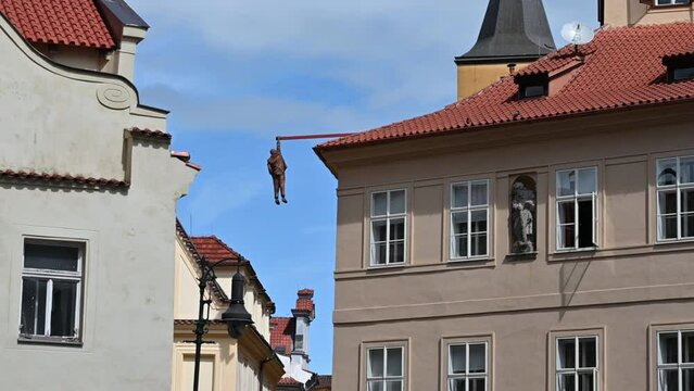 Prague, Czech Republic, August 4, 2023. Footage of Sigmund Freud hanging by David Čern&yacute;. Beautiful summer day with blue sky and white clouds.