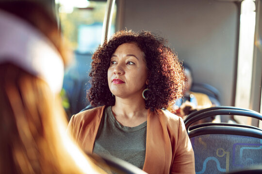 Contemplative Woman Riding the Bus During Golden Hour