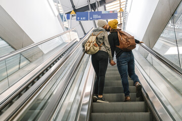 Young couple kissing on an escalator at the station, Berlin, Germany