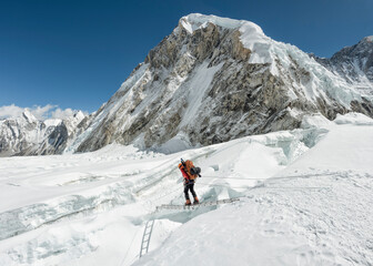 Fototapeta na wymiar Nepal, Solo Khumbu, Everest, Sagamartha National Park, Mountaineer crossing icefall at Western Cwm