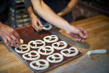 Bakers in bakery preparing fresh pretzls