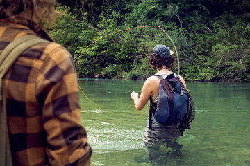 Slovenia, two men fly fishing in Soca river