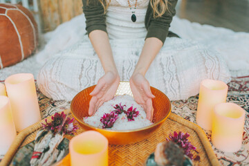 Hands in a salt bowl ceremony at a women's circle