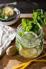 Glass of detox water with mint, ginger, rosmary and limes