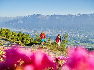 Austria, Tyrol, Couple hiking the Zirbenweg at the Patscherkofel
