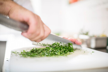 Cook chopping herbs