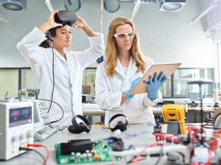 Female technicians working with tablet and vr glasses