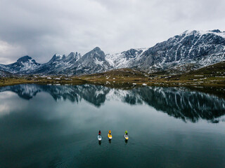 Aerial view of three people stand up paddle surfing, Leon, Spain